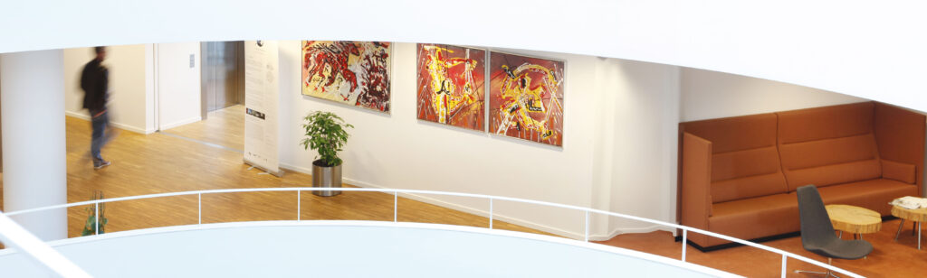 Colorful abstract paintings by Mikkel Urup displayed in a contemporary gallery setting.